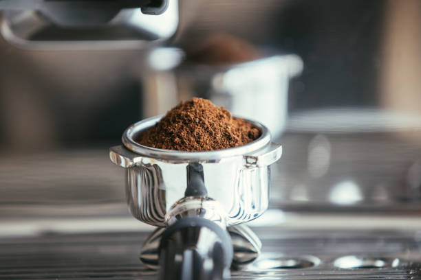 istock Coffee beans in a portafilter by the coffee grinder 1314342721