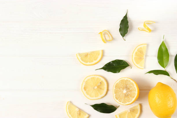 istock lemons and green leaves on a colored background. 1314342981