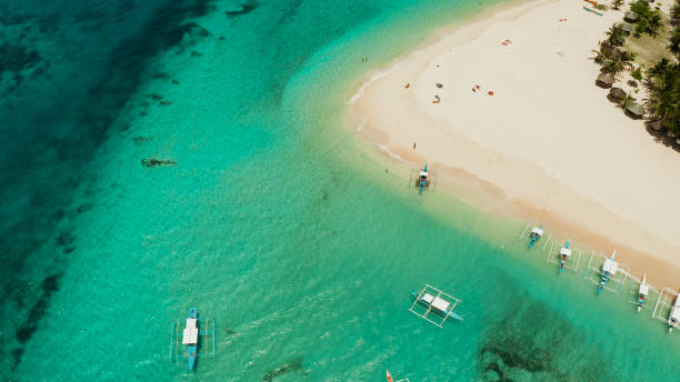 istock Tropical Daco Island with a sandy beach and tourists 1314344103