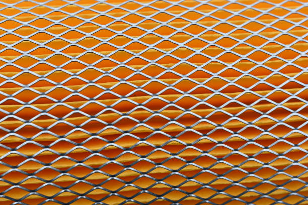 istock Orange car filter background with iron grille close-up 1314345202