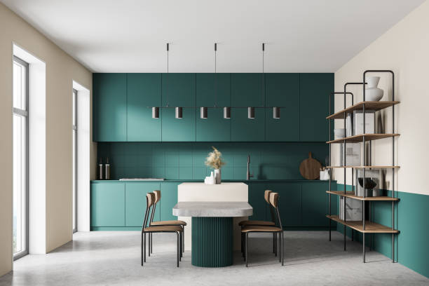 istock White and ocean green modern kitchen interior near window. Dining area with table. Concrete floor. Tall window. 1314346728