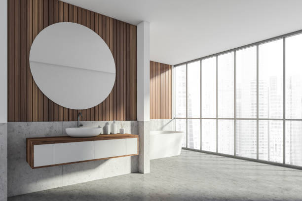 istock Bathroom interior with sink and bathtub, panoramic windows with city view 1314347116