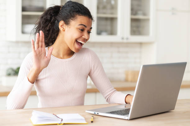 istock Young mixed-race female student waving at laptop 1314348194
