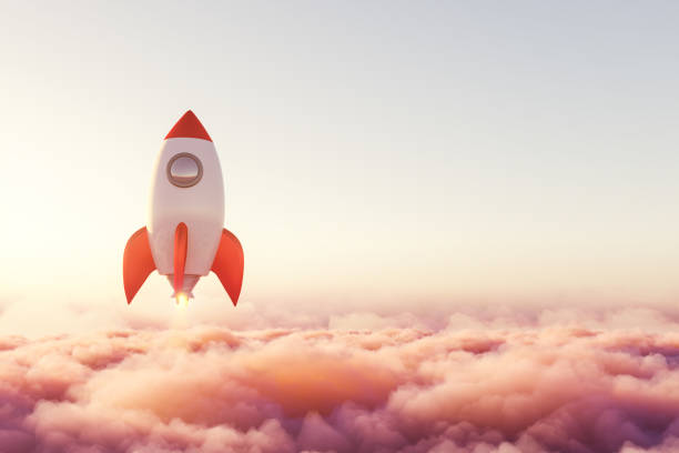 istock Rocket is rising above pink pastel clouds towards success 1314348366