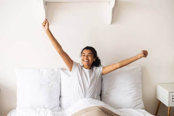 istock Young mixed-race woman waking up and stretching 1314348610