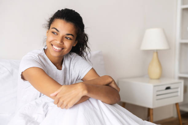 istock Mixed-race woman covered with soft blanket 1314348639