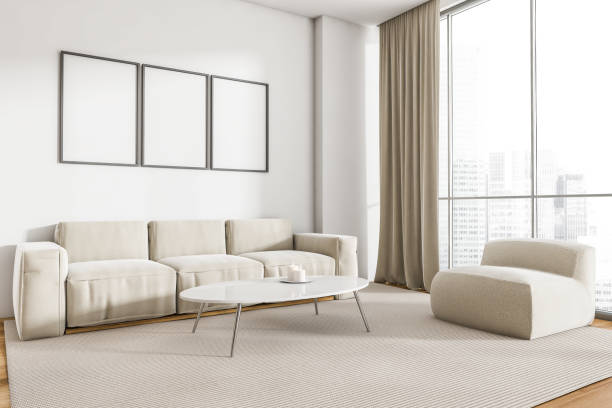 istock White sofa in living room interior with windows and three posters 1314349808