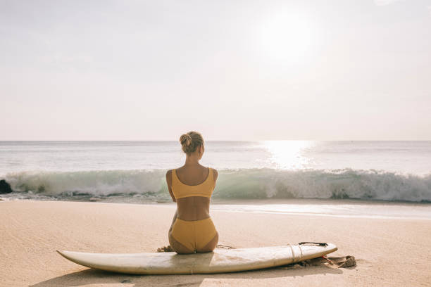 istock Woman sitting on her surfboard 1314350589