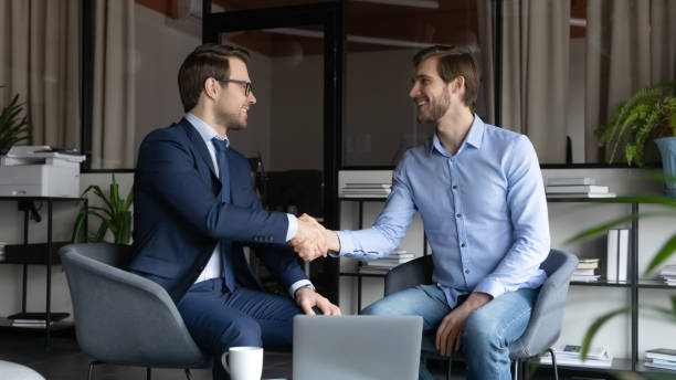istock Smiling male leader greeting skilled capable worker with reward promotion 1314352185