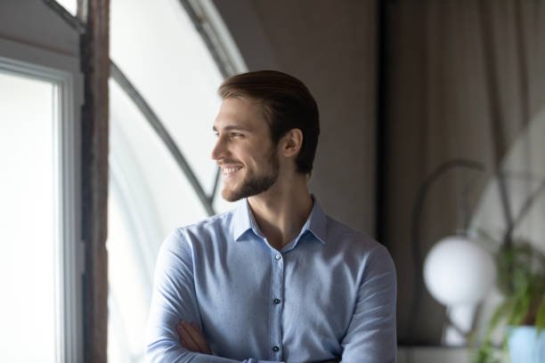 istock Successful young boss standing by window satisfied with career growth 1314352206