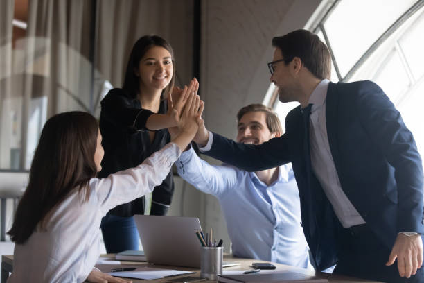 istock Excited business team uniting palms together on briefing in office 1314352239