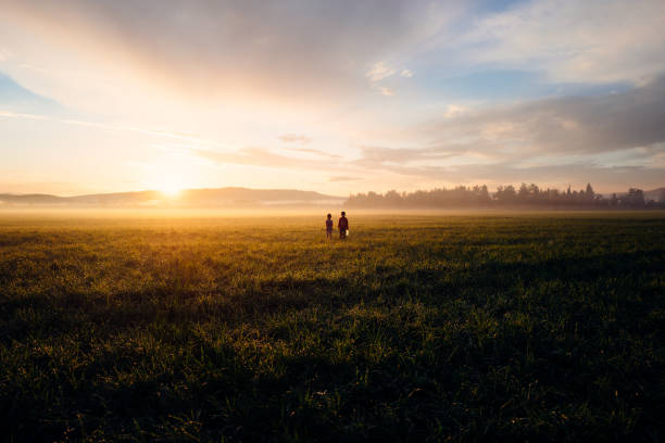 istock Two refugee children alone in a field 1314352247