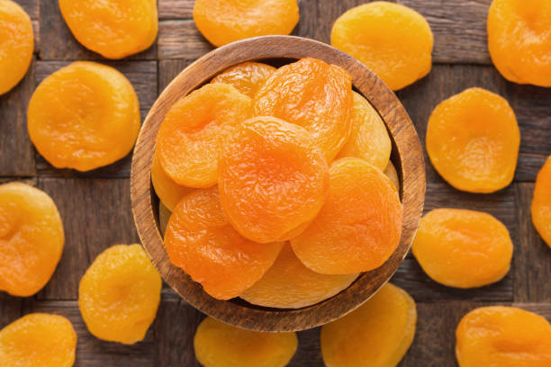 dried apricots in wooden bowl, top view. - 2546 imagens e fotografias de stock