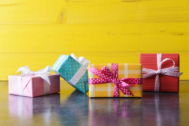 istock Set of various gift boxes over yellow wooden background with copy space 1314352555