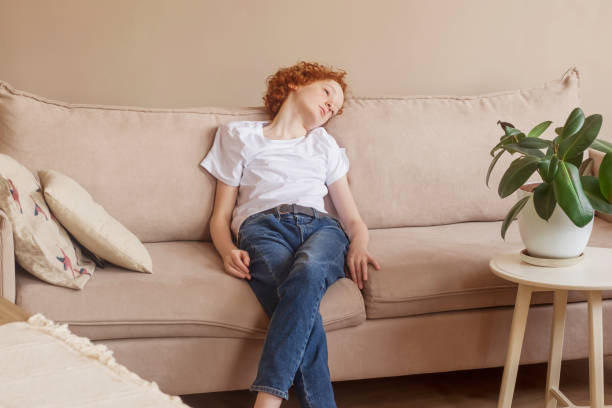 istock Empty space for text. A teenager is resting sitting on the couch. 1314353649