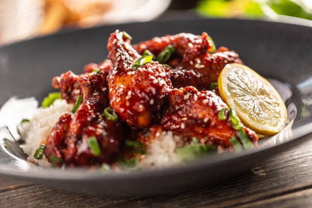 istock Marinated glazed sticky chicken thighs with seesame served with rice and coriander. 1314355380