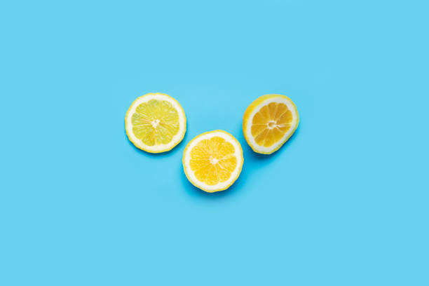 istock juicy fresh three lemon slices on a blue  background. Top view, flat lay. 1314355609