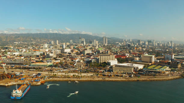 Modern city of Cebu with skyscrapers and buildings, Philippines Aerial view of panorama of Cebu city with skyscraper, buildings and seaport with ships and ferries in the early morning. Philippines. cebu province stock pictures, royalty-free photos & images