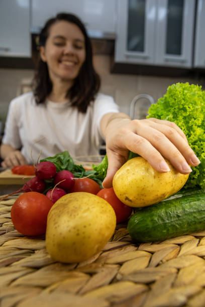 istock woman cooking taking potatoes kitchen home 1314356750
