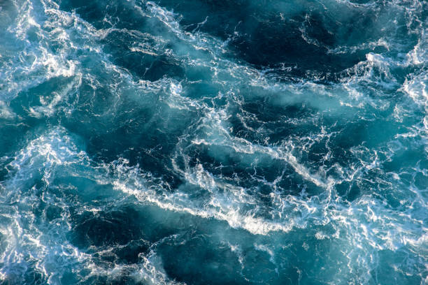 istock Stormy ocean waves backlit by the light of the setting sun. 1314357055
