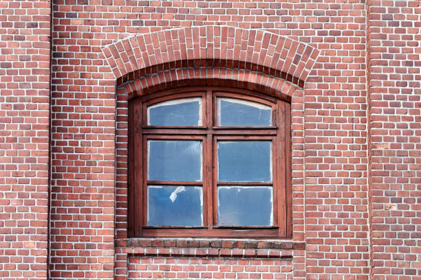istock One arched glass window on old red brick wall 1314357932