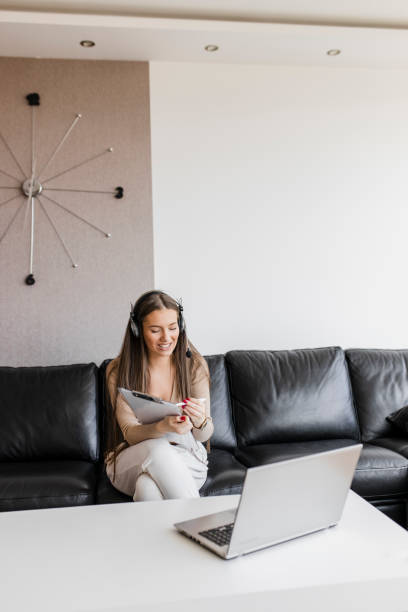 istock Teenage girl studying online using laptop and writing notes at home during quarantine 1314357937