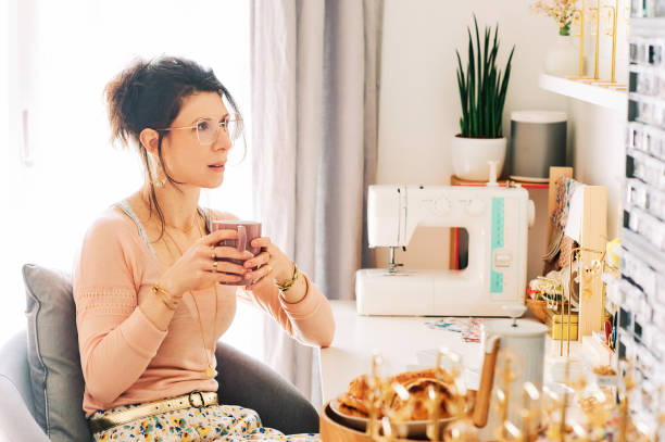 istock Jewelery creator drinking morning coffee in her working studio 1314358496