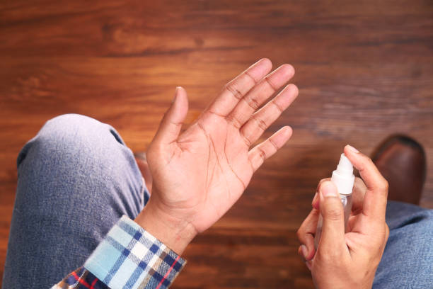 istock top view of young man hand using hand sanitizer spray. 1314359400