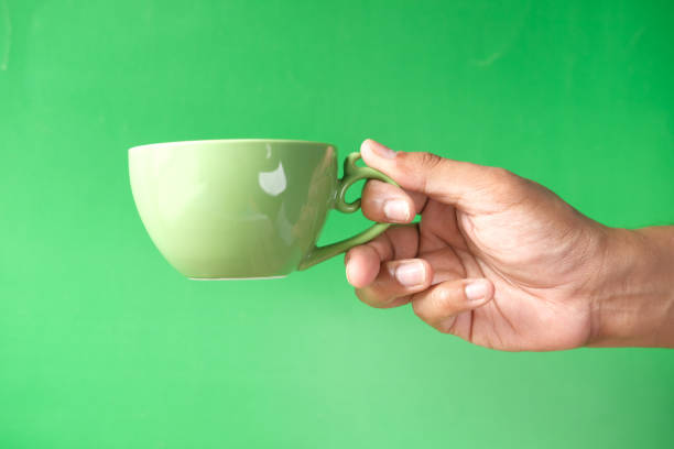 istock man hand holding a cup of green tea 1314361374