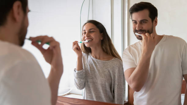 istock Happy couple brush teeth in home bathroom together 1314362473
