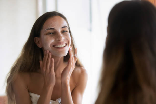 istock Smiling woman clean face in home bathroom 1314362501