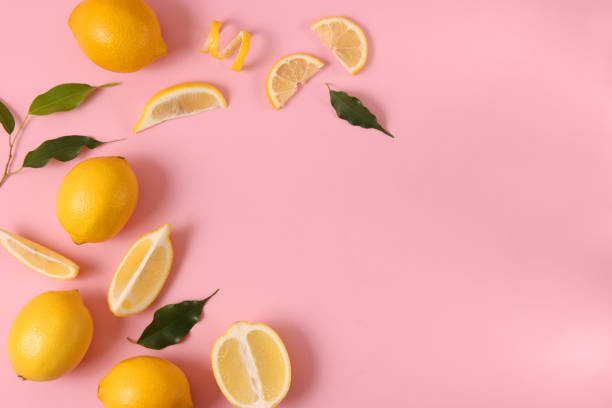 istock lemons and green leaves on a colored background. 1314362975