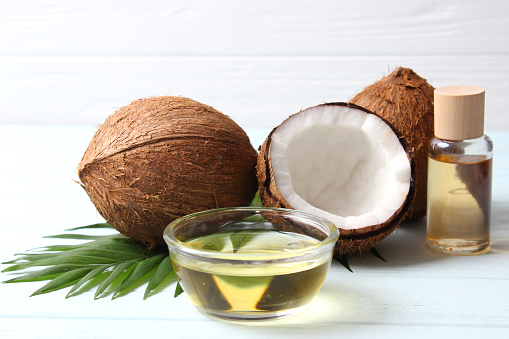 coconut oil and coconuts, palm branches close up. High quality photo