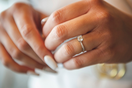 Hands of a bride with the engagement ring.