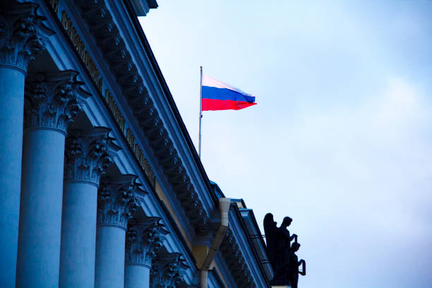 Flag of Russia Flag of Russia in Senate Square in Saint Petersburg, Russia at Sunset in March 2015 russian flag stock pictures, royalty-free photos & images