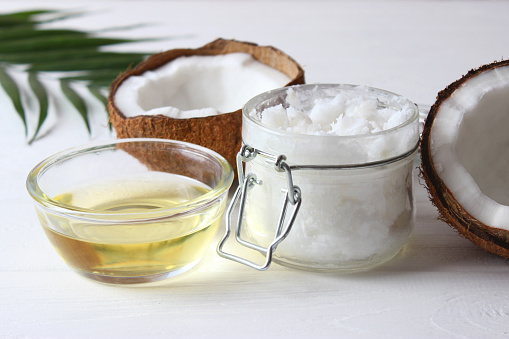 coconut oil and coconuts, palm branches close up. High quality photo