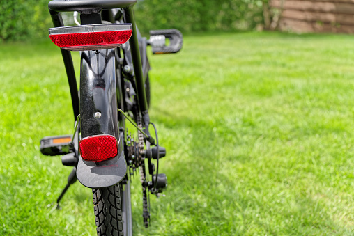 Close-up view of a bicycle from behind on green meadow