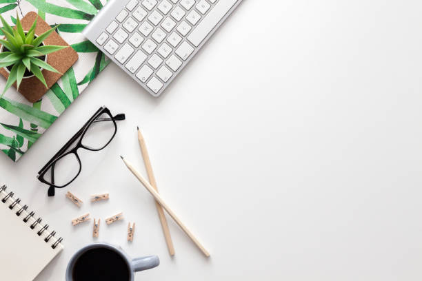 istock White home office desk. Copy space. Office stuff. Notebook, keyboard, succulent, gray cup with coffee. 1314366128