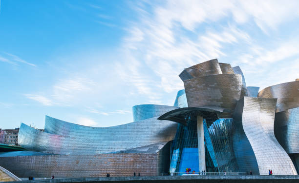 Cityscape of Bilbao by the river Nervion Panoramic view of the Guggenheim Museum on the bank of the Nervion river in Bilbao, Spain. frank gehry building stock pictures, royalty-free photos & images