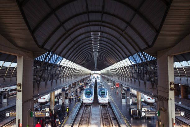 Passengers boarding high-speed trains in Santa Justa Station in Seville, Spain.