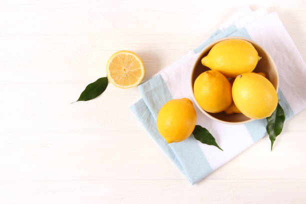 lemons and green leaves on a colored background.