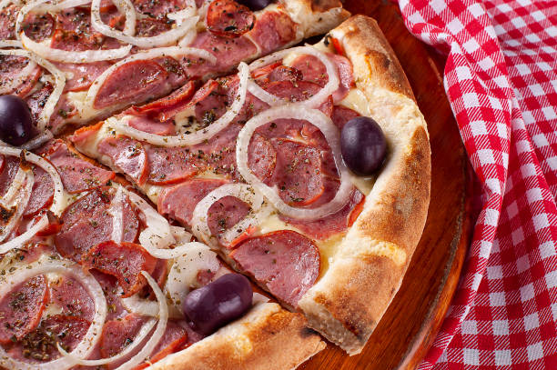 Brazilian style pizza with mozzarella cheese, pepperoni sausage and onion. Top view Brazilian style pizza with mozzarella cheese, pepperoni sausage and onion. Top view pepperoni pizza stock pictures, royalty-free photos & images