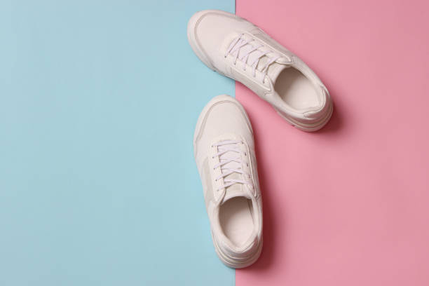 istock women's sneakers on a colored background top view. Women's shoes. 1314369024