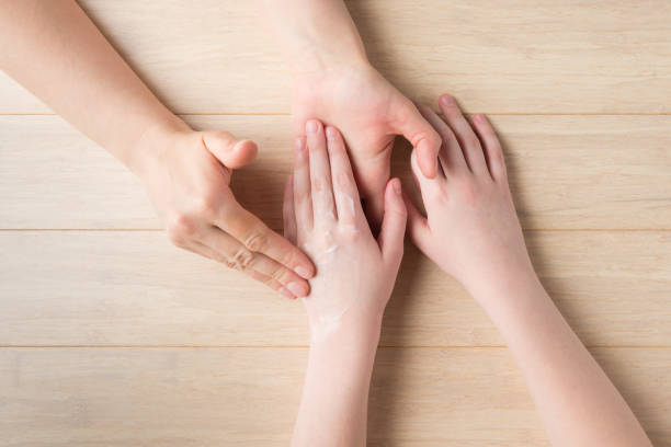 istock Hands skin care at home. Moisturizer apply 1314369764