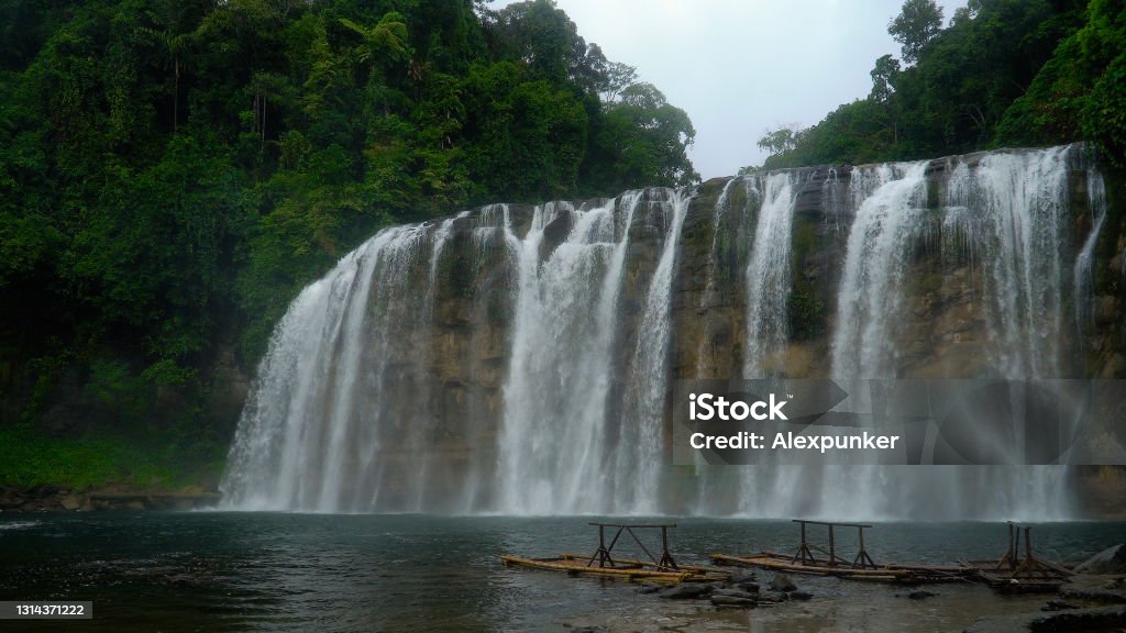 Beautiful tropical Tinuy-an Falls. Philippines, Mindanao Beautiful waterfall in green forest. Tropical Tinuy-an Falls in mountain jungle, Philippines, Mindanao. Waterfall in the tropical forest. Beauty Stock Photo