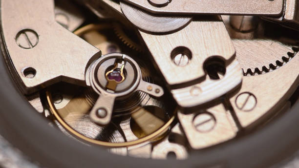 Automatic watch movement closeup macro showing hair balance spring moving and ruby jewels Closeup macro of an automatic watch internal movement parts clockworks photos stock pictures, royalty-free photos & images