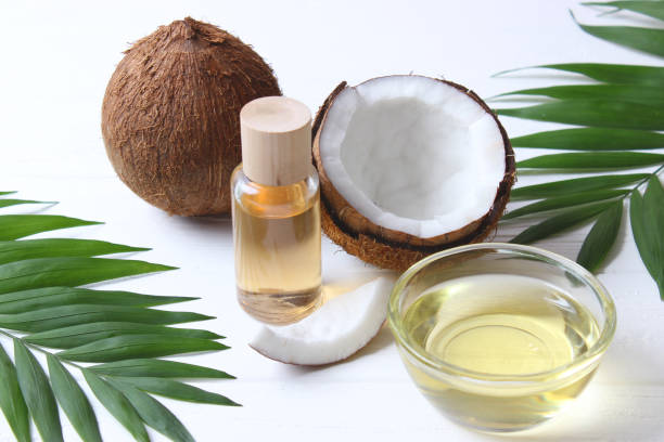 istock coconut oil and coconuts, palm branches close up 1314375612