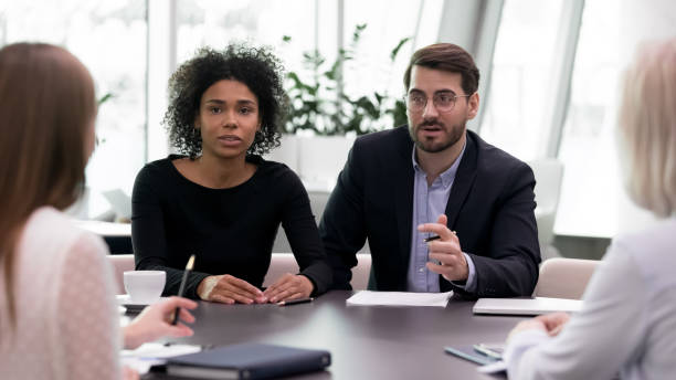 istock Multiracial employees engaged in team discussion at meeting 1314375782