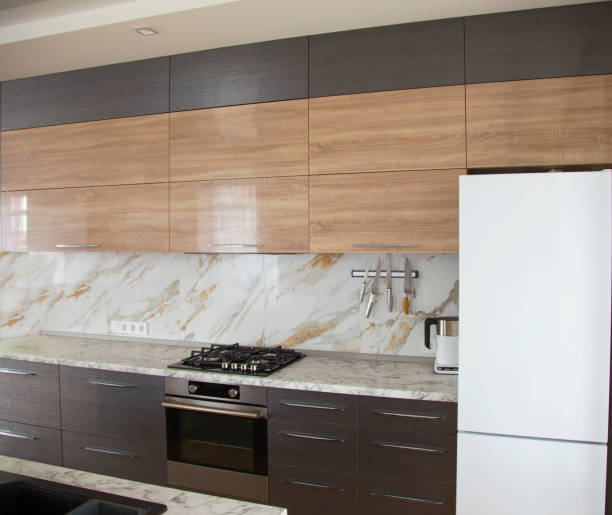 Modern and sunny kitchen with marble floor, elements of the working part. Design, interiors.
