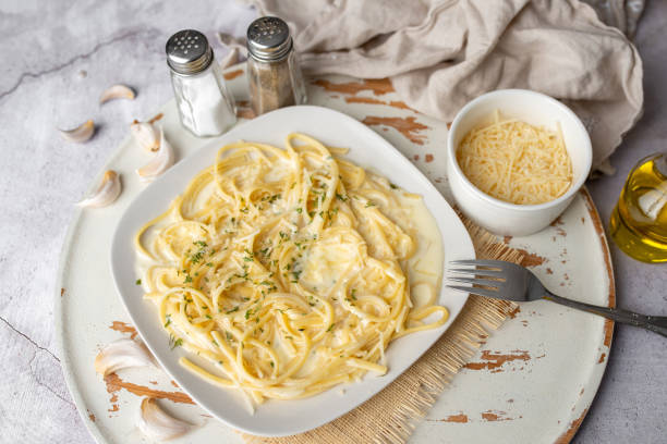 istock Alfredo pasta dinner with creamy white sauce with herbs seasoning. 1314378782